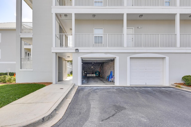 2410 Scenic Gulf Dr Unit 101C, Miramar Beach, FL 32550 - view of property featuring a garage and asphalt driveway