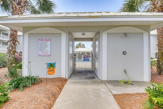 2410 Scenic Gulf Dr Unit 101C, Miramar Beach, FL 32550 - view of exterior entry featuring stucco siding and a gate