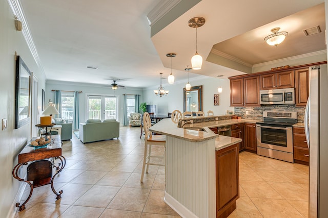 2410 Scenic Gulf Dr Unit 101C, Miramar Beach, FL 32550 - kitchen with stainless steel appliances, a peninsula, a kitchen breakfast bar, a sink, and open floor plan