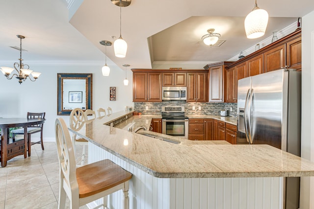 2410 Scenic Gulf Dr Unit 101C, Miramar Beach, FL 32550 - kitchen featuring stainless steel appliances, crown molding, tasteful backsplash, a peninsula, and brown cabinets