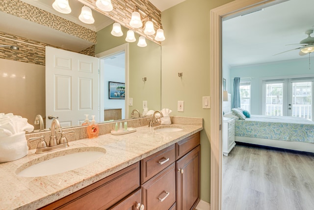 2410 Scenic Gulf Dr Unit 101C, Miramar Beach, FL 32550 - ensuite bathroom featuring wood finished floors, double vanity, ceiling fan, and ornamental molding