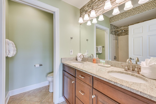 2410 Scenic Gulf Dr Unit 101C, Miramar Beach, FL 32550 - bathroom with tile patterned floors, double vanity, toilet, and baseboards