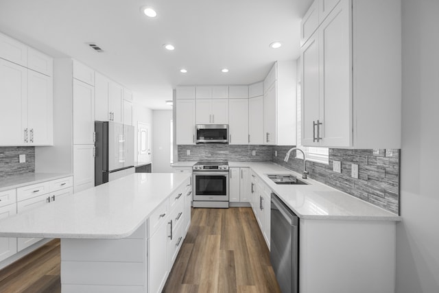 518 Second Ave, Destin, FL 32541 - kitchen with stainless steel appliances, a sink, a kitchen island, recessed lighting, and dark wood-style flooring