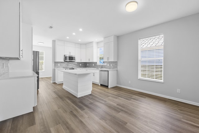 518 Second Ave, Destin, FL 32541 - kitchen featuring appliances with stainless steel finishes, tasteful backsplash, white cabinetry, light countertops, and recessed lighting