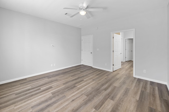518 Second Ave, Destin, FL 32541 - unfurnished bedroom featuring wood finished floors, baseboards, and a ceiling fan