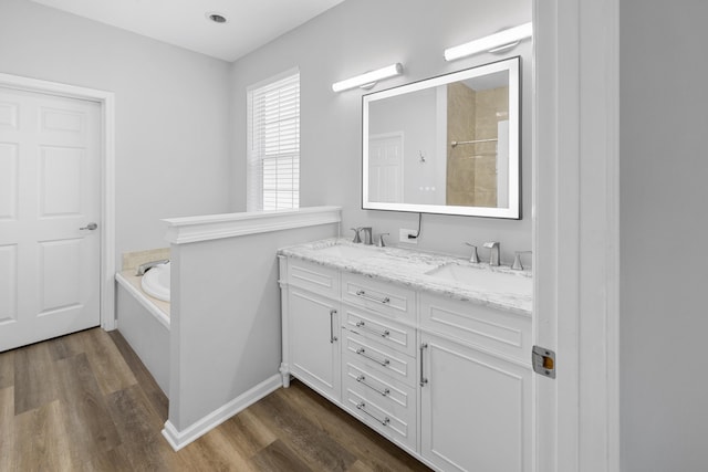 518 Second Ave, Destin, FL 32541 - full bathroom with a bath, wood finished floors, double vanity, and a shower