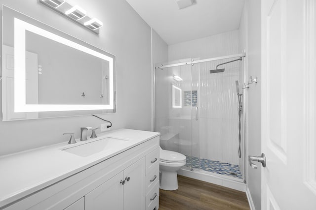 518 Second Ave, Destin, FL 32541 - full bathroom with toilet, a stall shower, vanity, and wood finished floors