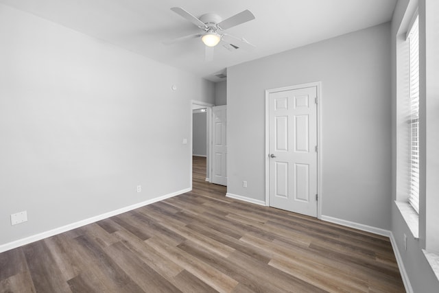 518 Second Ave, Destin, FL 32541 - unfurnished bedroom featuring wood finished floors, baseboards, and ceiling fan