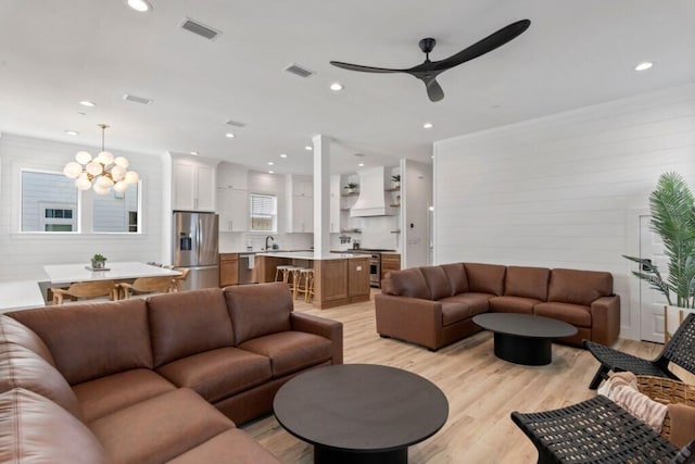 136 Lee Pl, Santa Rosa Beach, FL 32459 - living room featuring light wood-style floors, a chandelier, ceiling fan, recessed lighting, and wooden walls
