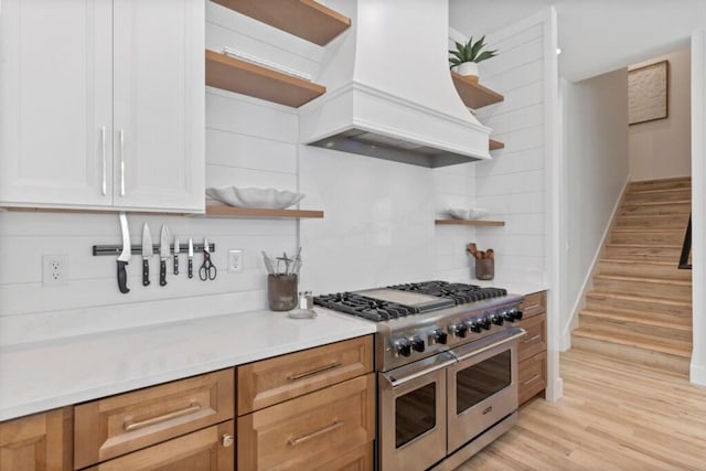 136 Lee Pl, Santa Rosa Beach, FL 32459 - kitchen with open shelves, premium range hood, double oven range, and light wood-type flooring
