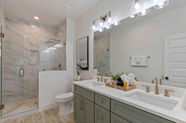 136 Lee Pl, Santa Rosa Beach, FL 32459 - bathroom with toilet, a marble finish shower, double vanity, wood finished floors, and recessed lighting