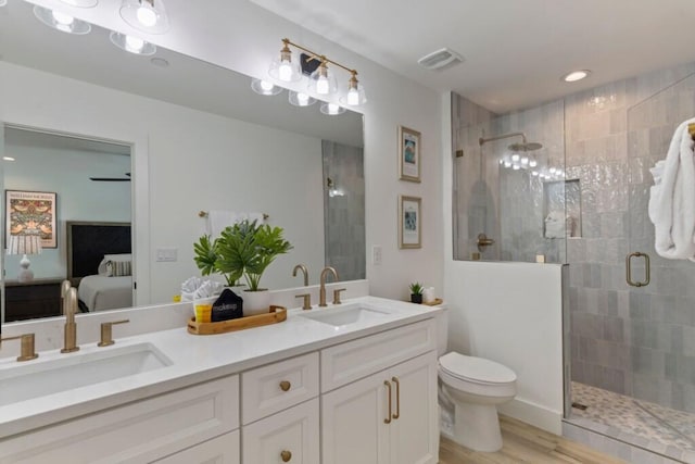 136 Lee Pl, Santa Rosa Beach, FL 32459 - ensuite bathroom featuring a shower stall, toilet, double vanity, wood finished floors, and recessed lighting