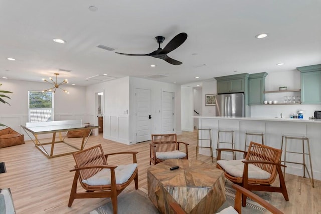 136 Lee Pl, Santa Rosa Beach, FL 32459 - living area featuring light wood-style flooring, a ceiling fan, recessed lighting, wainscoting, and a chandelier