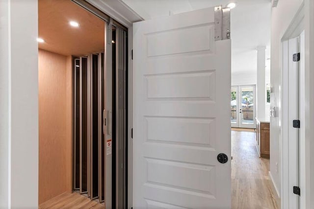 136 Lee Pl, Santa Rosa Beach, FL 32459 - corridor featuring light wood-style floors, elevator, french doors, and recessed lighting
