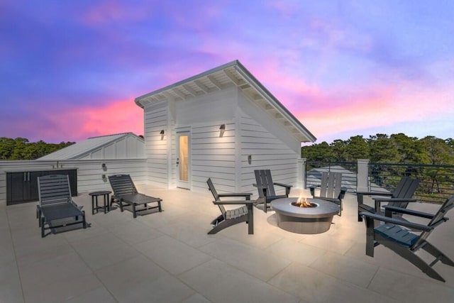136 Lee Pl, Santa Rosa Beach, FL 32459 - patio terrace at dusk featuring an outdoor fire pit and a patio area