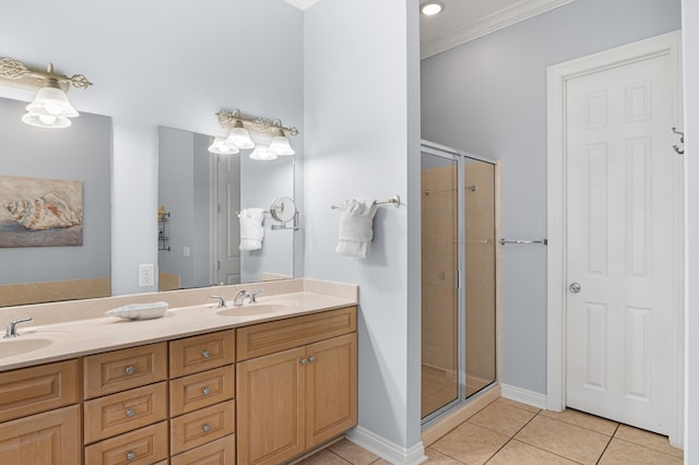 431 La Valencia Cir, Panama City Beach, FL 32413 - full bathroom with tile patterned flooring, crown molding, double vanity, a stall shower, and baseboards