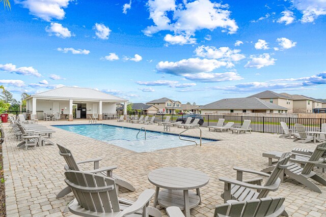 103 Ridgeway Cir, Crestview, FL 32536 - community pool featuring a patio and a residential view