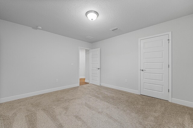 103 Ridgeway Cir, Crestview, FL 32536 - empty room featuring carpet flooring, a textured ceiling, baseboards, and a smoke detector