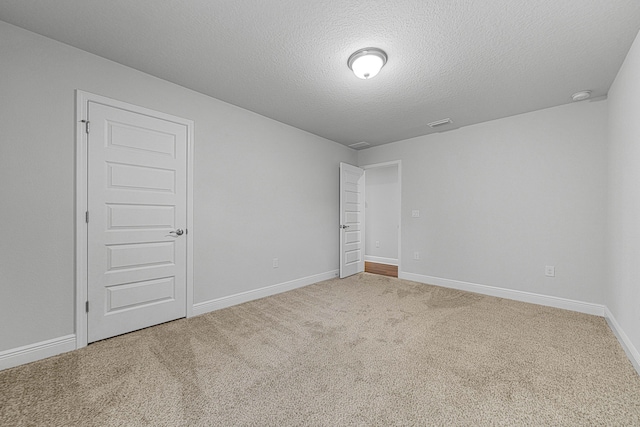 103 Ridgeway Cir, Crestview, FL 32536 - empty room with carpet, baseboards, a textured ceiling, and a smoke detector
