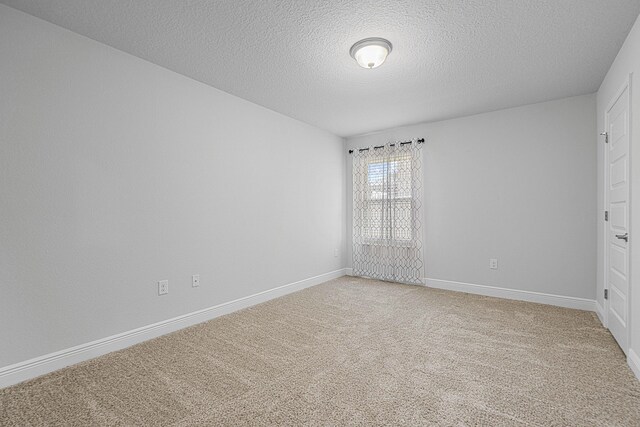 103 Ridgeway Cir, Crestview, FL 32536 - unfurnished bedroom with a textured ceiling, light carpet, and baseboards