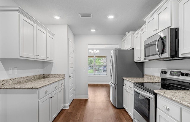 103 Ridgeway Cir, Crestview, FL 32536 - kitchen featuring stainless steel appliances, dark wood finished floors, a chandelier, white cabinets, and recessed lighting