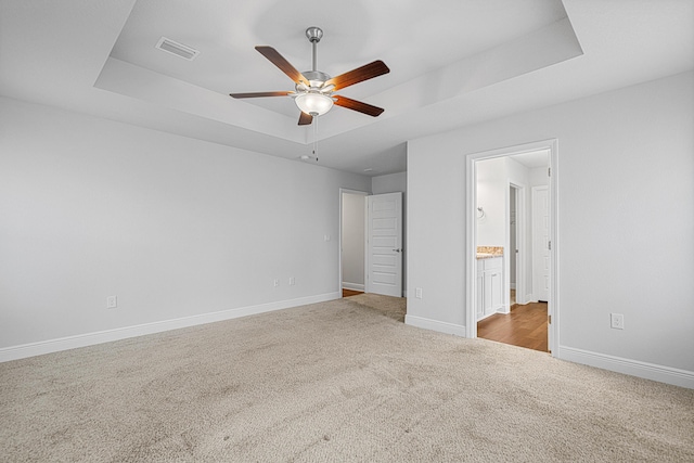 103 Ridgeway Cir, Crestview, FL 32536 - unfurnished bedroom featuring a raised ceiling, carpet flooring, baseboards, ensuite bathroom, and a ceiling fan