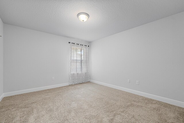 103 Ridgeway Cir, Crestview, FL 32536 - carpeted empty room with a textured ceiling and baseboards