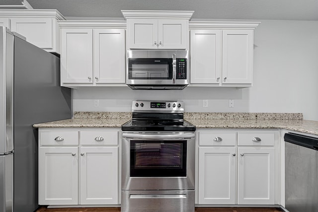 103 Ridgeway Cir, Crestview, FL 32536 - kitchen with stainless steel appliances, white cabinetry, and light stone countertops