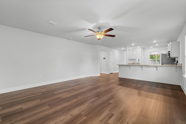 103 Ridgeway Cir, Crestview, FL 32536 - unfurnished living room featuring ceiling fan, dark wood finished floors, baseboards, recessed lighting, and a sink