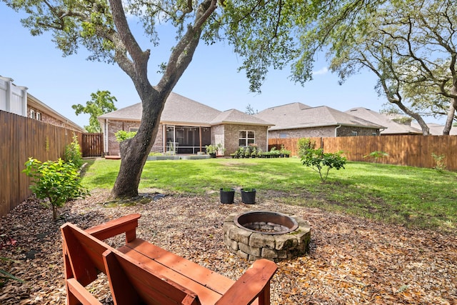 20 6th Ave, Shalimar, FL 32579 - back of house with an outdoor fire pit, brick siding, and a sunroom