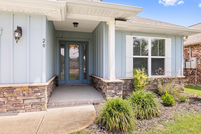 20 6th Ave, Shalimar, FL 32579 - property entrance featuring stone siding, board and batten siding, roof with shingles, and covered porch