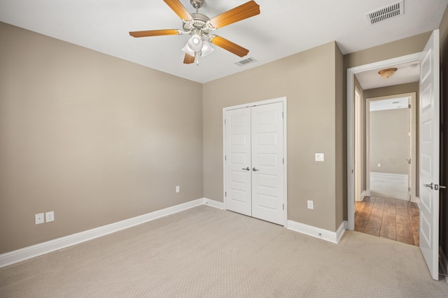 20 6th Ave, Shalimar, FL 32579 - unfurnished bedroom with light colored carpet, a closet, baseboards, and ceiling fan