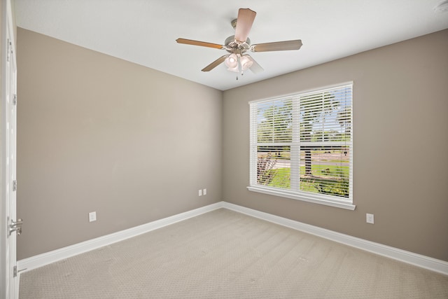 20 6th Ave, Shalimar, FL 32579 - spare room featuring light carpet, baseboards, and a ceiling fan