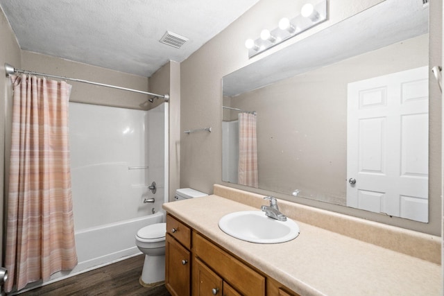 1014 Airport Rd Unit 155, Destin, FL 32541 - bathroom featuring toilet, shower / bath combination with curtain, vanity, and wood finished floors