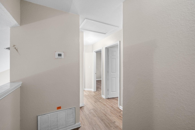 1014 Airport Rd Unit 155, Destin, FL 32541 - corridor with light wood finished floors, attic access, and baseboards