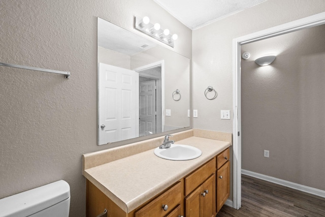 1014 Airport Rd Unit 155, Destin, FL 32541 - bathroom featuring vanity, toilet, and wood finished floors