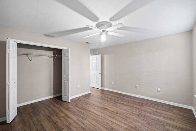 1014 Airport Rd Unit 155, Destin, FL 32541 - unfurnished bedroom featuring wood finished floors, baseboards, a closet, and a ceiling fan