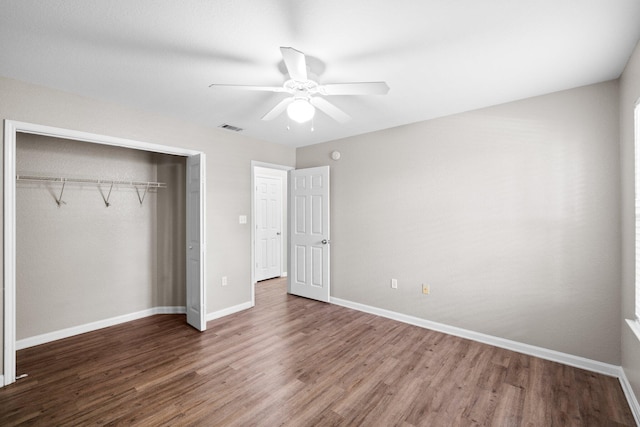 1014 Airport Rd Unit 155, Destin, FL 32541 - unfurnished bedroom featuring wood finished floors, a closet, baseboards, and ceiling fan