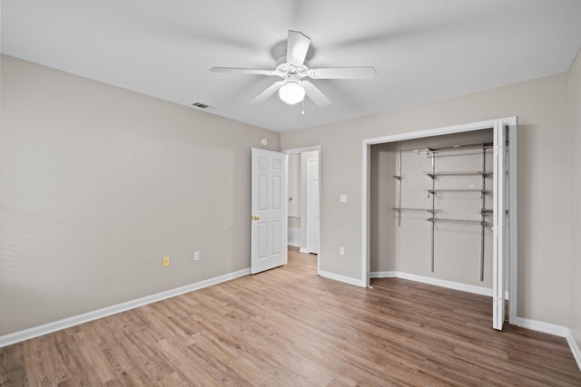 1014 Airport Rd Unit 155, Destin, FL 32541 - unfurnished bedroom with wood finished floors, baseboards, a closet, and a ceiling fan