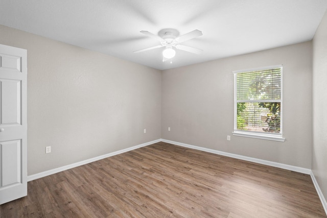 1014 Airport Rd Unit 155, Destin, FL 32541 - empty room featuring wood finished floors, baseboards, and ceiling fan