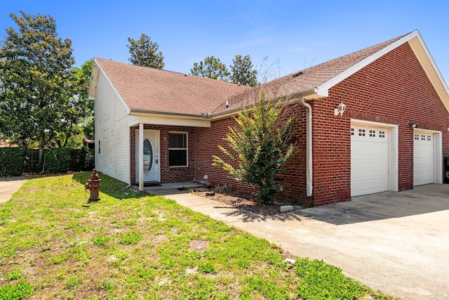 1014 Airport Rd Unit 155, Destin, FL 32541 - view of front of house featuring brick siding, driveway, roof with shingles, and an attached garage