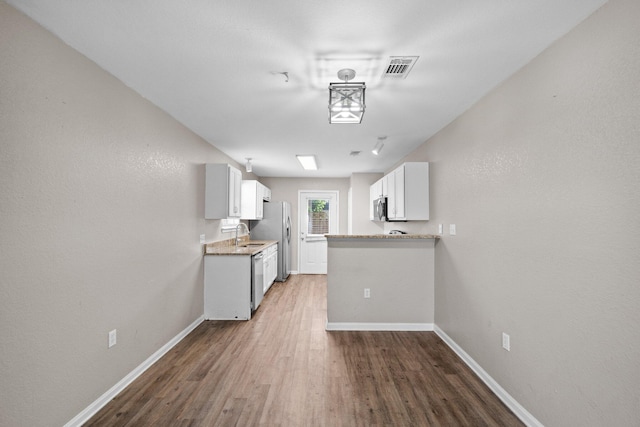 1014 Airport Rd Unit 155, Destin, FL 32541 - kitchen with appliances with stainless steel finishes, baseboards, and wood finished floors
