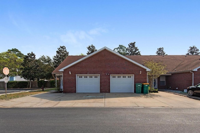 1014 Airport Rd Unit 155, Destin, FL 32541 - view of front facade with brick siding, driveway, and a garage