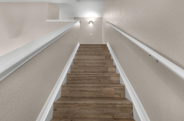 1014 Airport Rd Unit 155, Destin, FL 32541 - staircase with wood finished floors and a textured wall