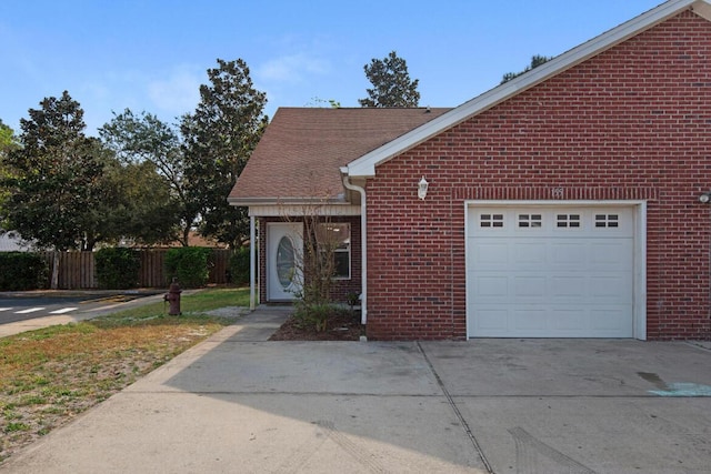 1014 Airport Rd Unit 155, Destin, FL 32541 - view of front of house with driveway, brick siding, and a garage
