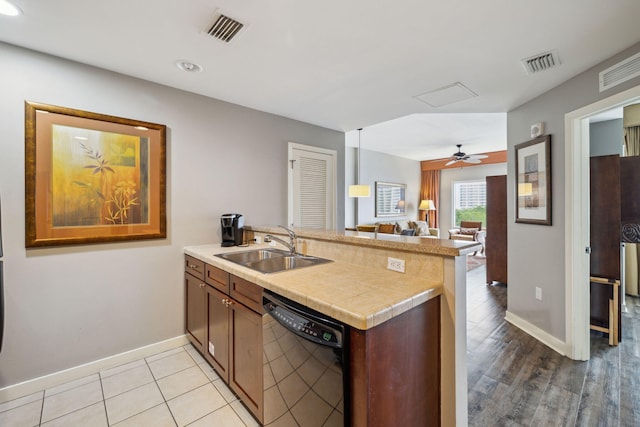 5000 S Sandestin Blvd Unit 6407, Miramar Beach, FL 32550 - kitchen with black dishwasher, a sink, a peninsula, baseboards, and open floor plan