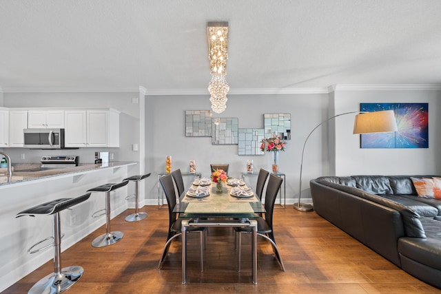 17545 Front Beach Rd Unit 1301, Panama City Beach, FL 32413 - dining area with crown molding, dark wood-type flooring, baseboards, and a chandelier