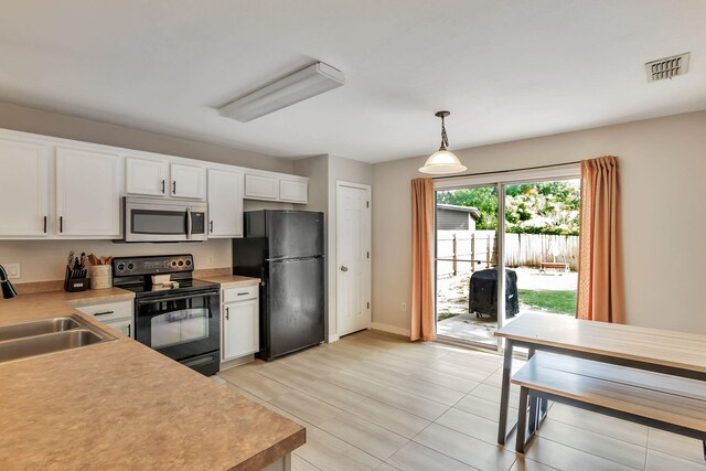 1951 Ambassador Dr, Gulf Breeze, FL 32563 - kitchen featuring black appliances, a sink, white cabinetry, light countertops, and pendant lighting