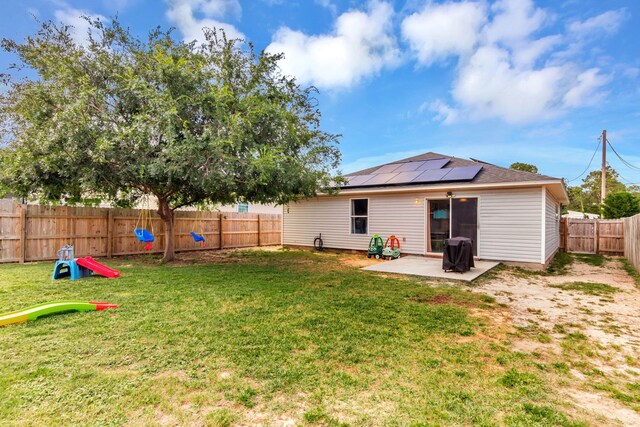 1951 Ambassador Dr, Gulf Breeze, FL 32563 - rear view of house featuring roof mounted solar panels and a patio area
