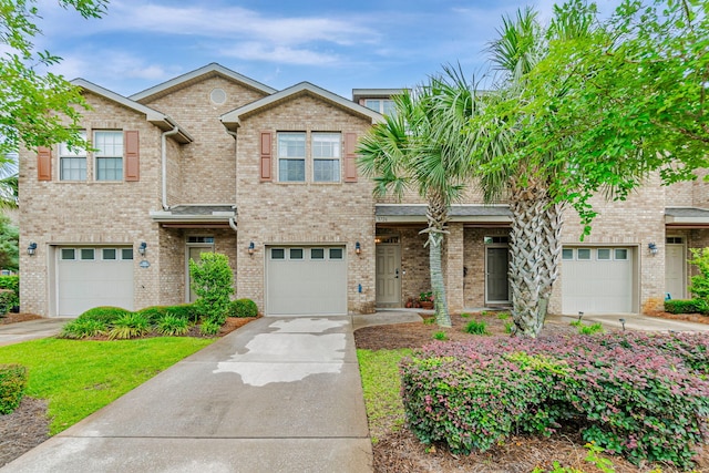 8726 Brown Pelican Cir, Navarre, FL 32566 - view of front of house with concrete driveway, brick siding, and a garage